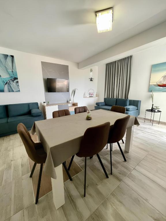 a living room with a table and chairs at Accommodation Ventus 2 in Baška Voda