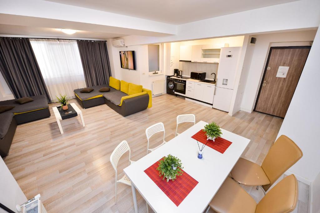 an open living room with a white table and chairs at Bucharest Accommodation Apartments in Bucharest