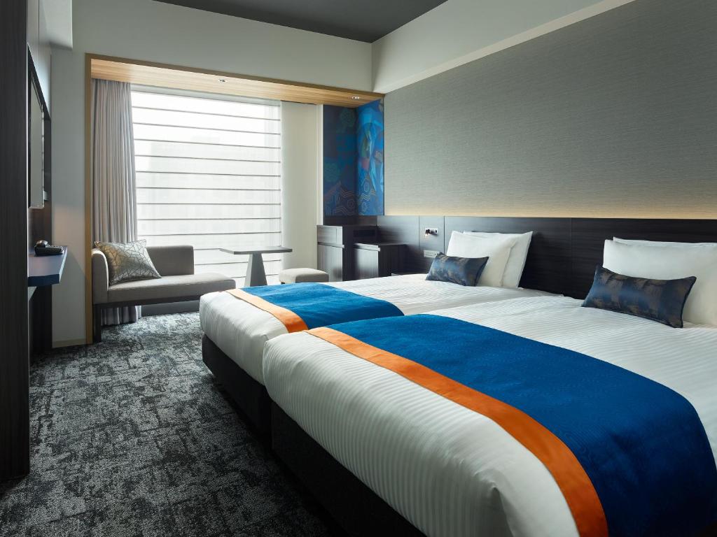 Postel nebo postele na pokoji v ubytování Mitsui Garden Hotel Ginza-gochome