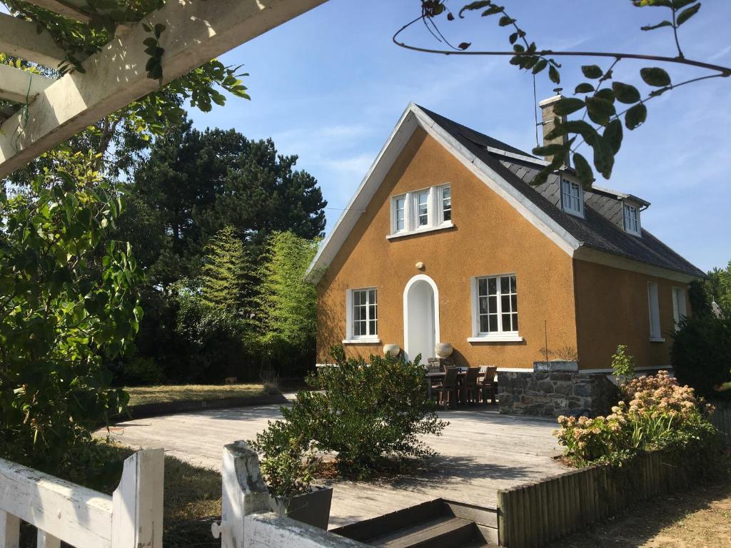 a brick house with a black roof at La Farandole, coastal family home in Agon Coutainville