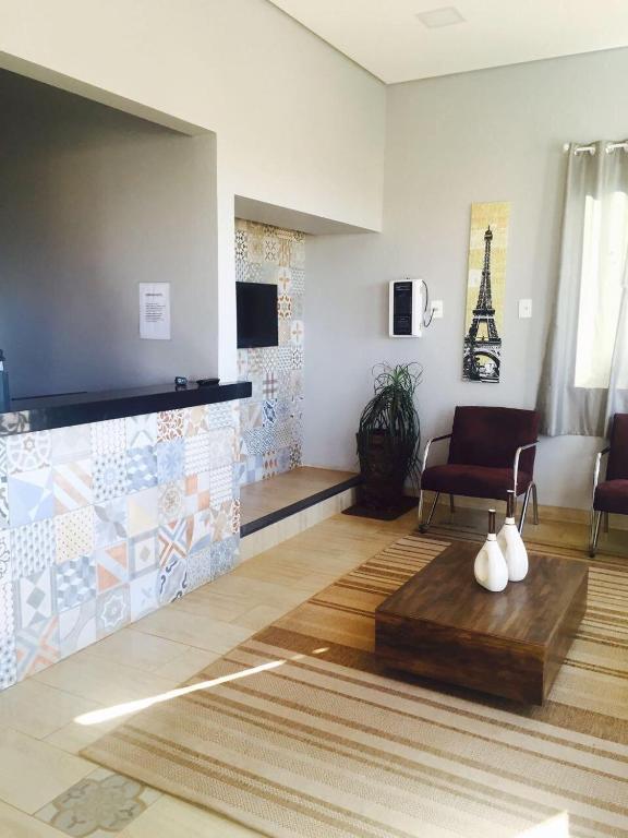 a living room with a couch and a table at Cerrado Gran Hotel in Rio Verde