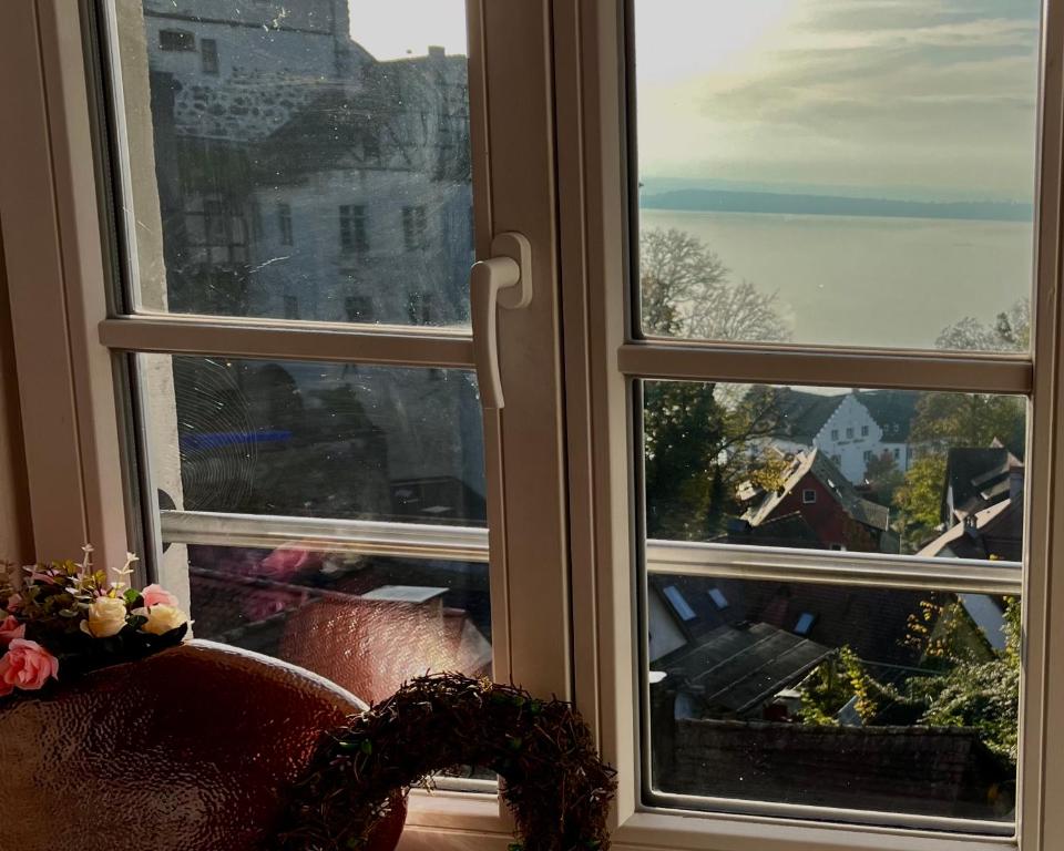 a window with a view of a city at Burgblick-Romantik für 2 mit Seesicht in Meersburg