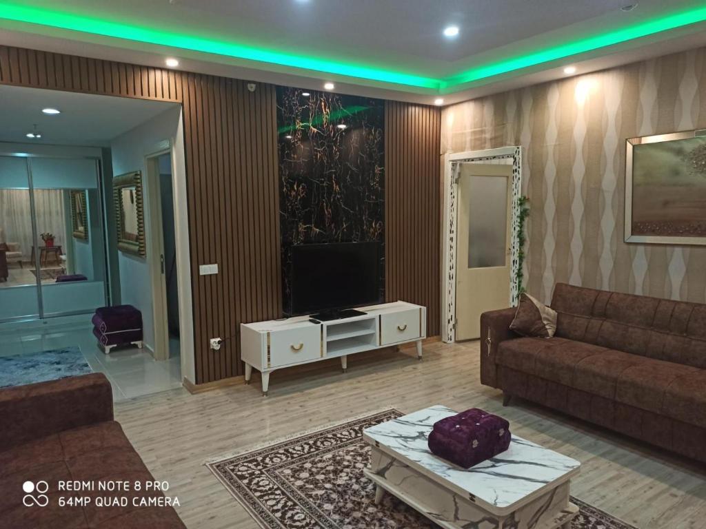 a living room with a couch and a tv at ENTIRE 3 Bedroom Apartment with FREE PARKING in Esenyurt