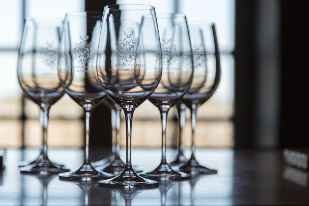 a row of wine glasses sitting on a table at Château du Tertre in Arsac