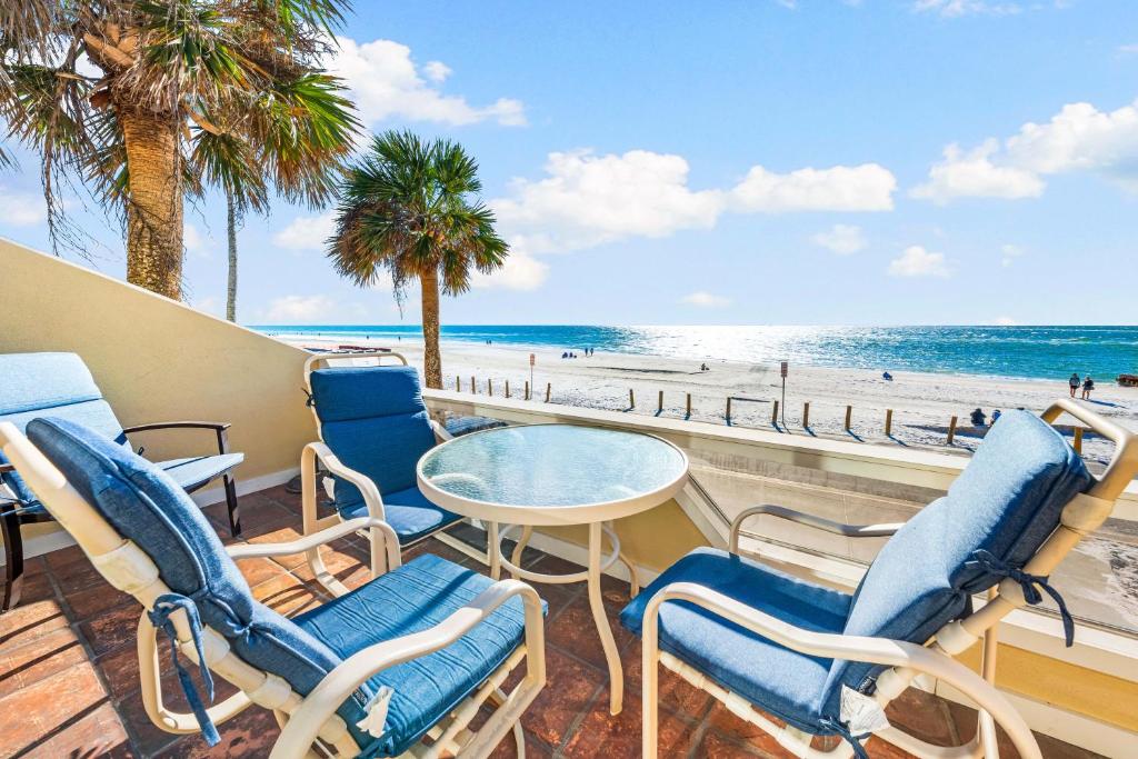 a balcony with chairs and a table and the beach at Fanta-Sea 47 By Beachside Management in Siesta Key