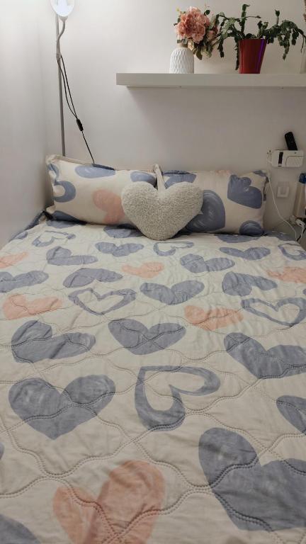 - une chambre avec un lit doté d'un couvre-lit et de coeurs dans l'établissement centre villeOpéra,Gare st Lazare , cozy studio, à Paris