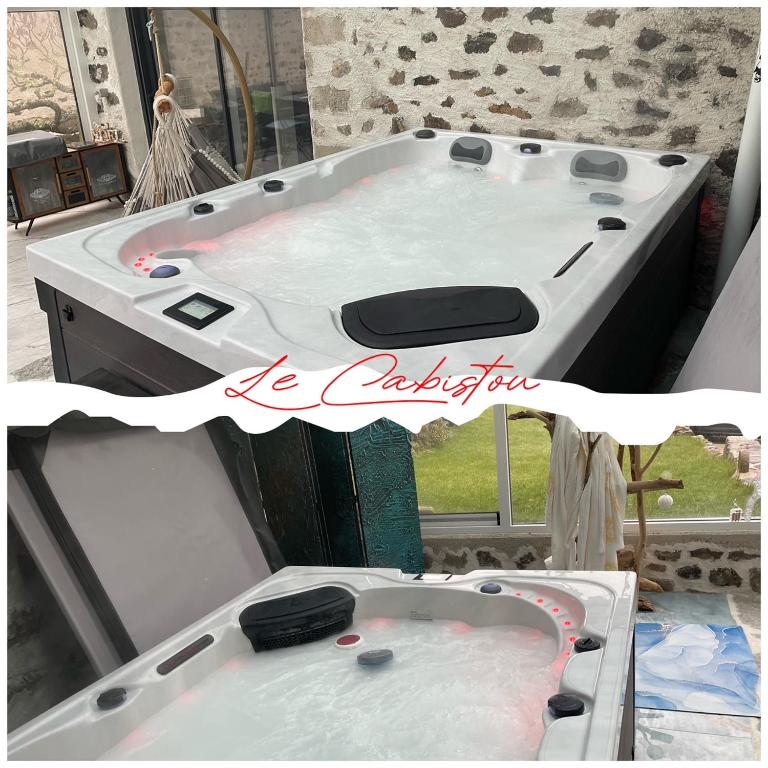 une baignoire blanche devant une fenêtre dans l'établissement Le Cabistou, à Saint-Saturnin