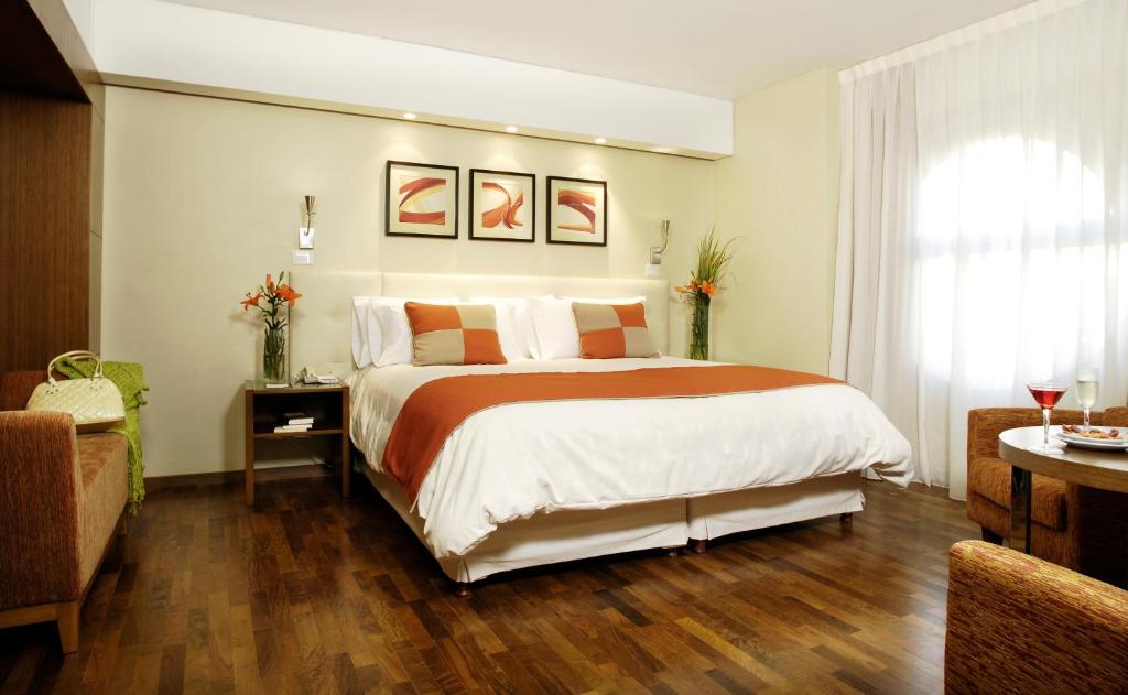 a bedroom with a large bed and a window at Regente Palace Hotel in Buenos Aires