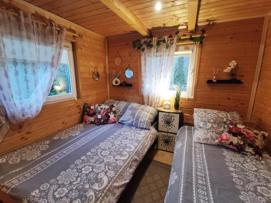 a room with two beds in a log cabin at Eden in Sędziszowa
