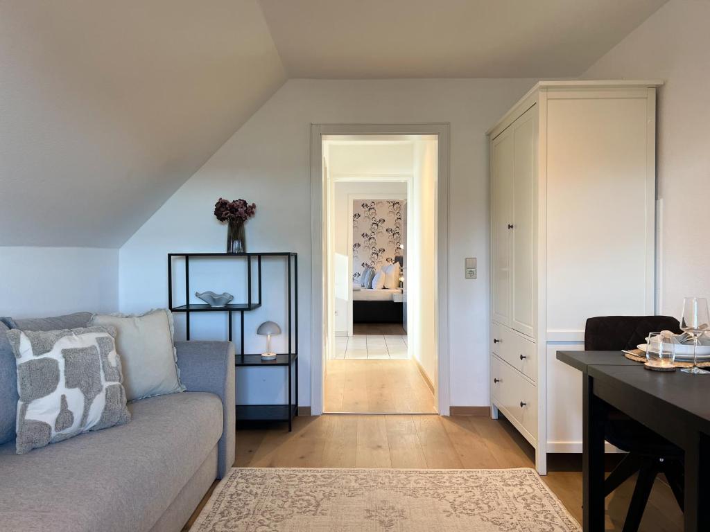 a living room with a couch and a table at Panorama Apartment mit Titisee-Blick - Villa Hubertus in Feldberg