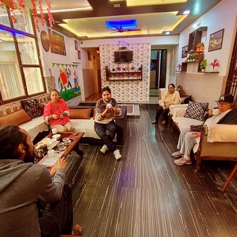 a group of people sitting in a living room at Mayur Villa in Agra