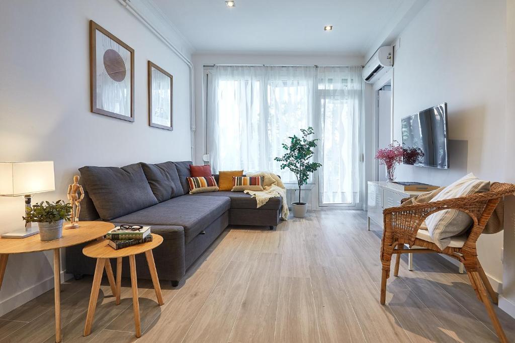 a living room with a couch and a table at BBarcelona Gracia Apartment in Barcelona