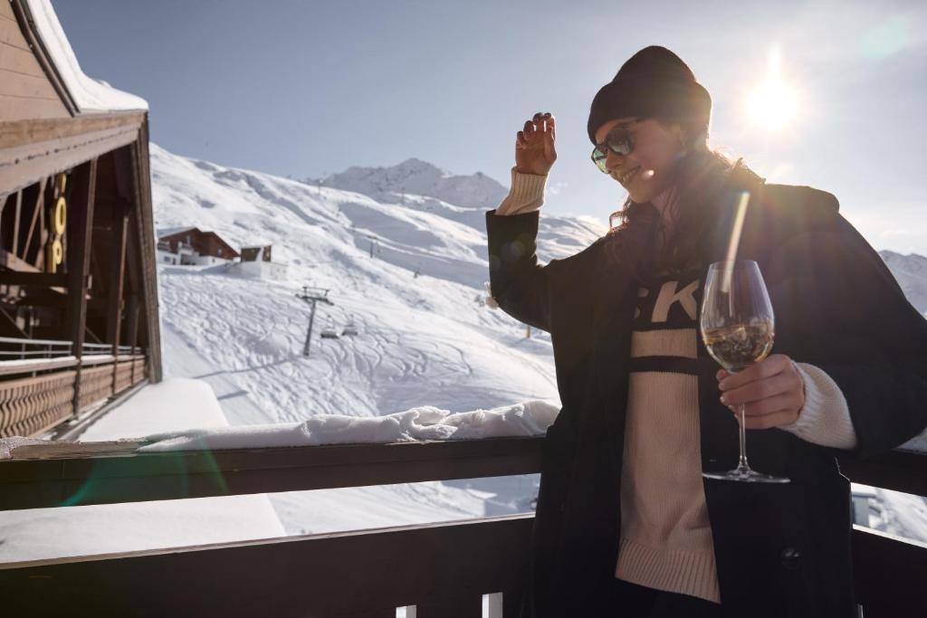 a man holding a glass of wine on a ski slope at TOP Hotel Hochgurgl in Hochgurgl