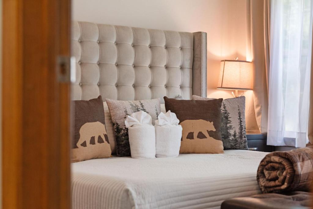 a bedroom with a bed with a white headboard and pillows at Love Lace Retreat in Albrightsville