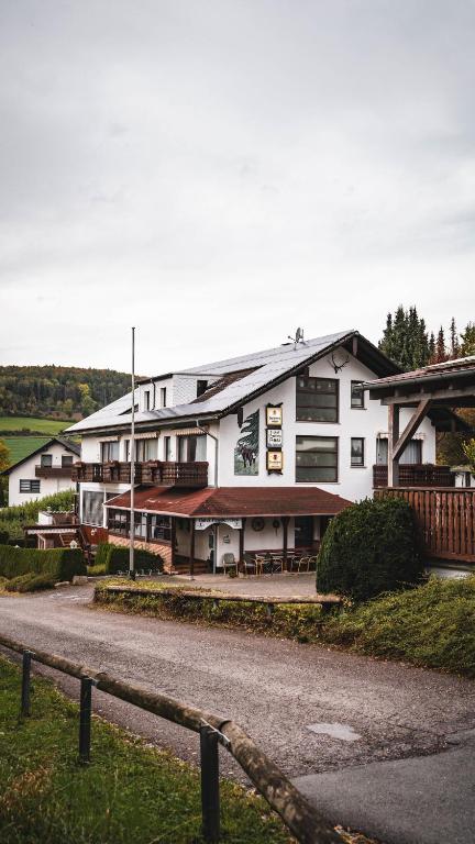 a large white building on the side of a road at Hotel Resi Beverungen in Beverungen