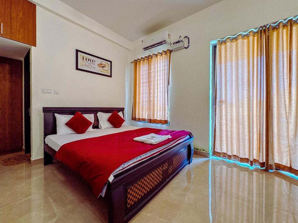 a bedroom with a bed with red pillows at Private 3BHK Villa with Indoor Pool in Chengalpattu