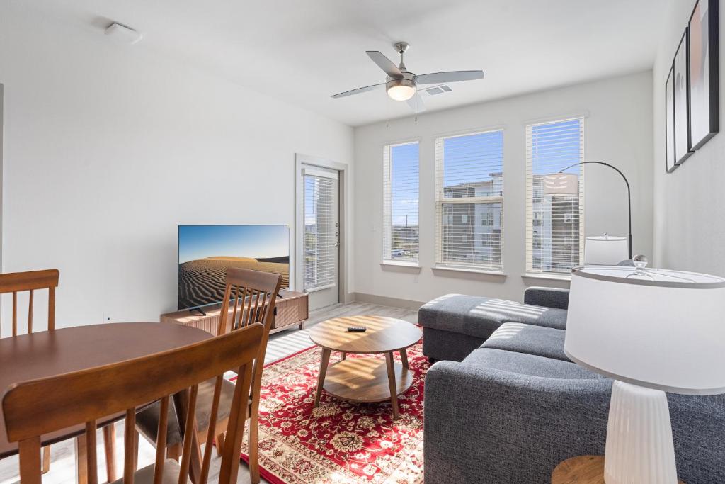 a living room with a couch and a table at Luxury Apartments Near Airport in Austin
