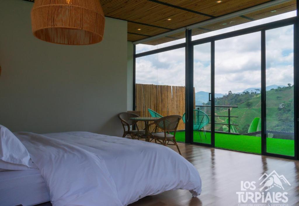 Postel nebo postele na pokoji v ubytování Glamping Los Turpiales