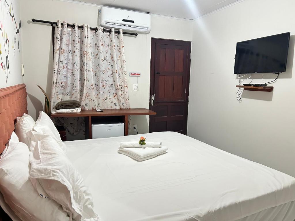 Cama ou camas em um quarto em Pousada Paraíso dos Milagres