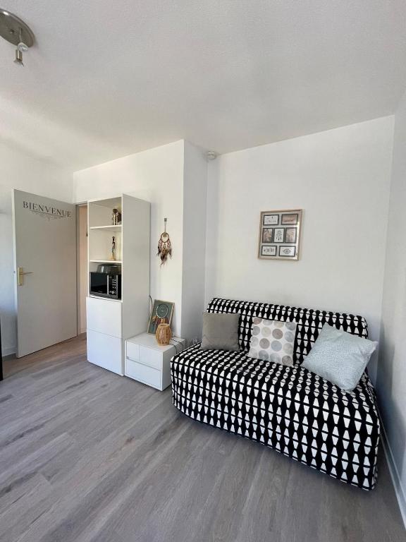 - un salon avec un canapé noir et blanc dans l'établissement Le Rêveur au bord du Lez, à Montpellier