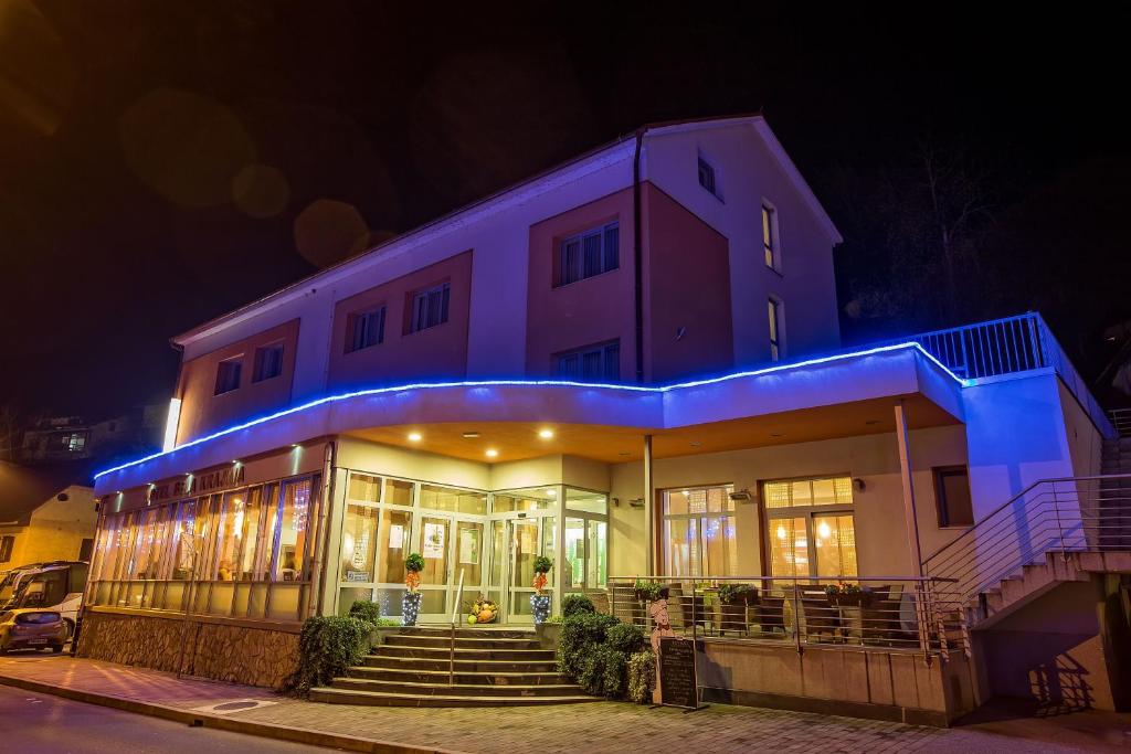 a building with blue lights on it at night at Hotel Bela Krajina in Metlika