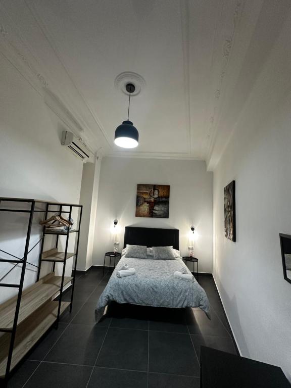 a bedroom with a bed and two bunk beds at Home Turia Pio Apartamento de 3 habitaciones in Valencia