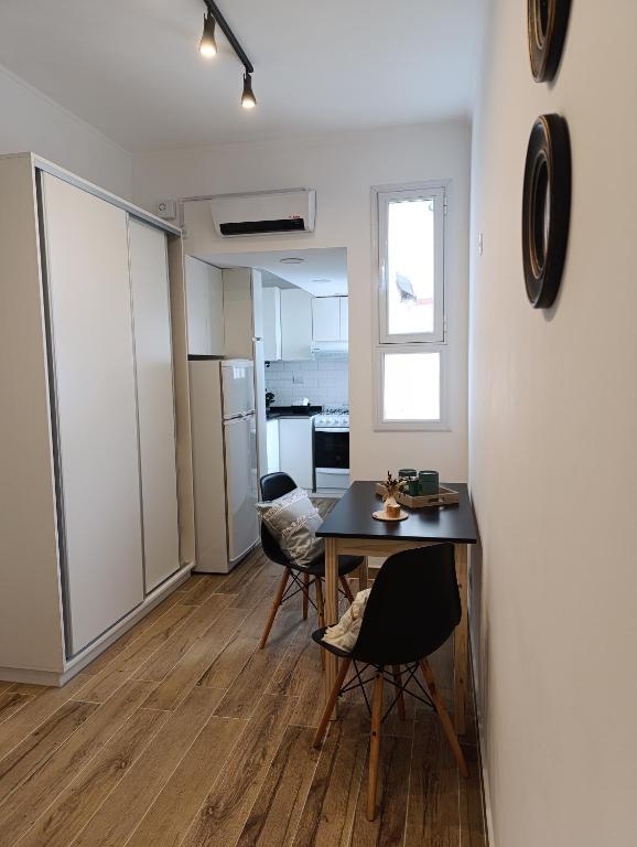 a kitchen and dining room with a table and chairs at Zit Flat Colon in Mar del Plata