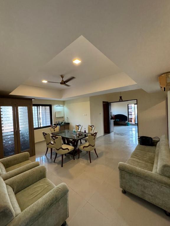 a large living room with a table and chairs at The Chapters in Goa