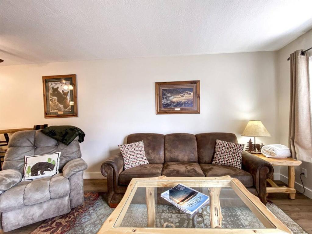 a living room with a couch and a table at Inn Building Condo 113, Ground Level, Pool Side in Garden City