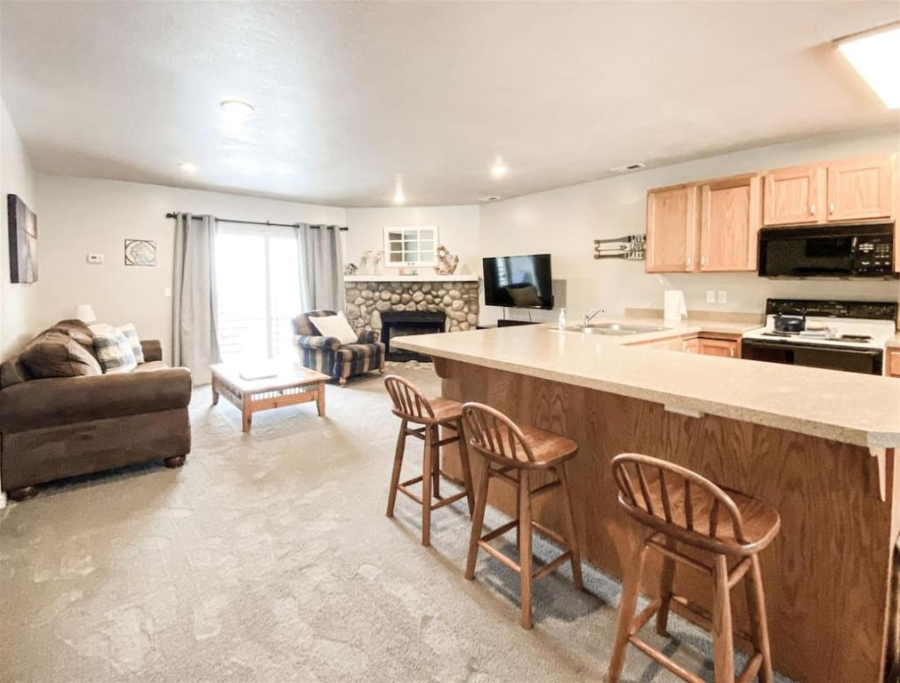 a kitchen and living room with a bar and a couch at 14-Plex 218 in Garden City