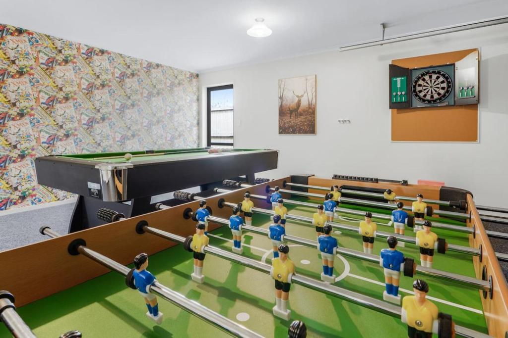 a group of toy people in a room with a pool table at Pool-Table, Projector, Fooseball -By KOSH BNB in Hamilton