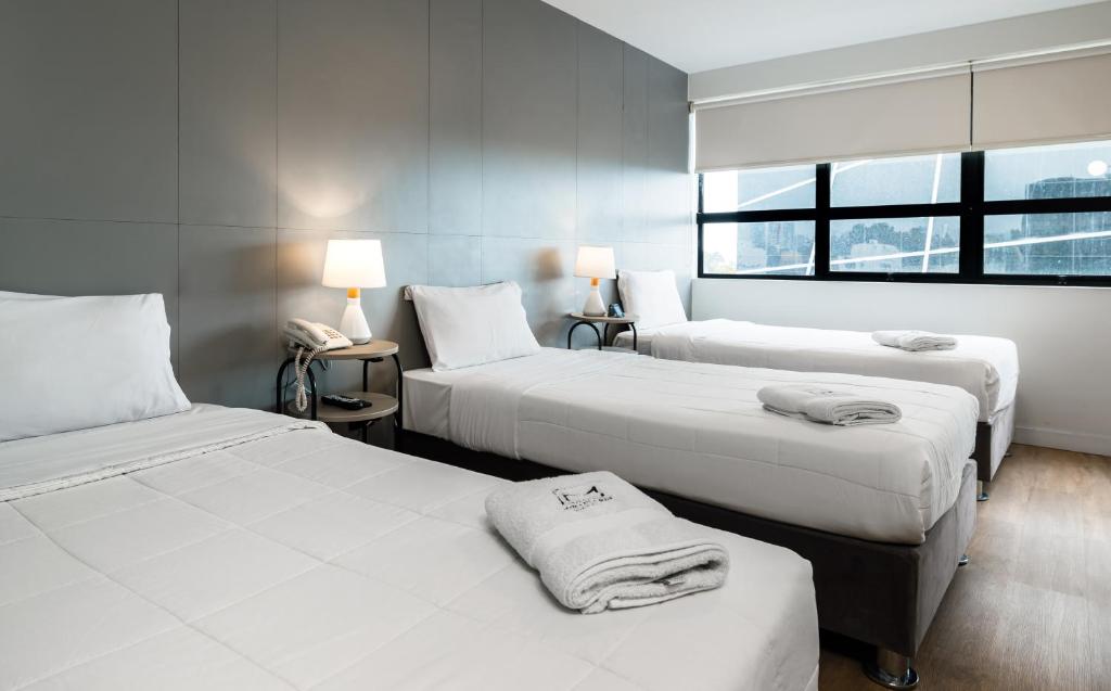Postel nebo postele na pokoji v ubytování Miraflores Suites Centro