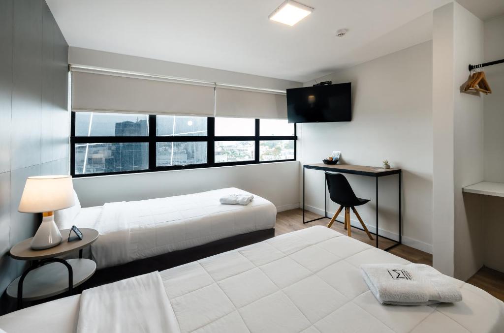 Postel nebo postele na pokoji v ubytování Miraflores Suites Centro