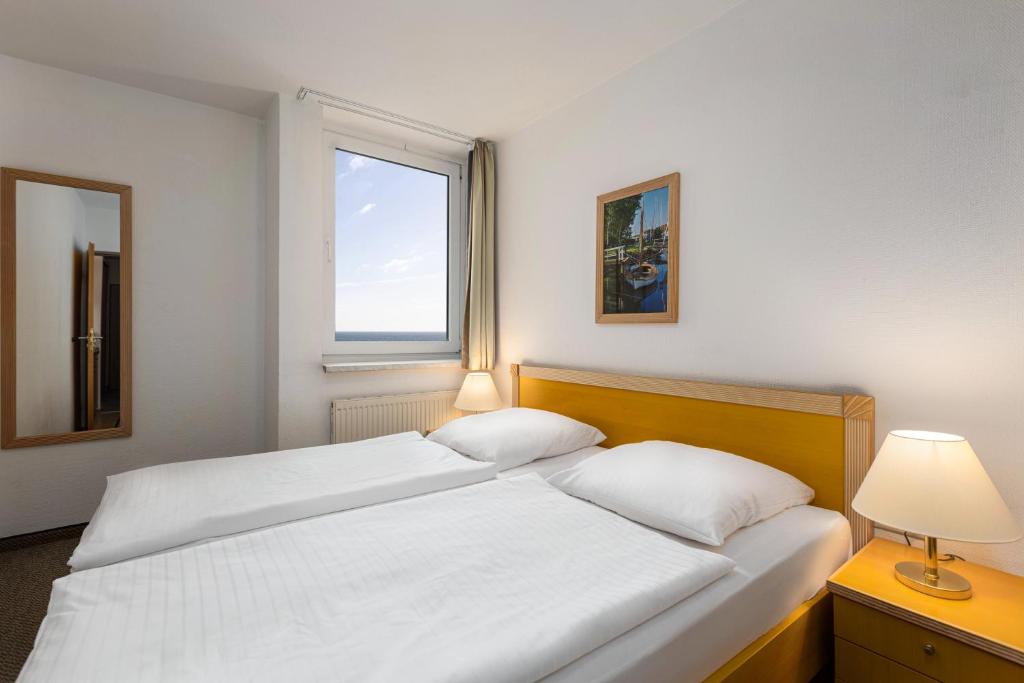 Voodi või voodid majutusasutuse IFA Fehmarn Hotel & Ferien-Centrum toas