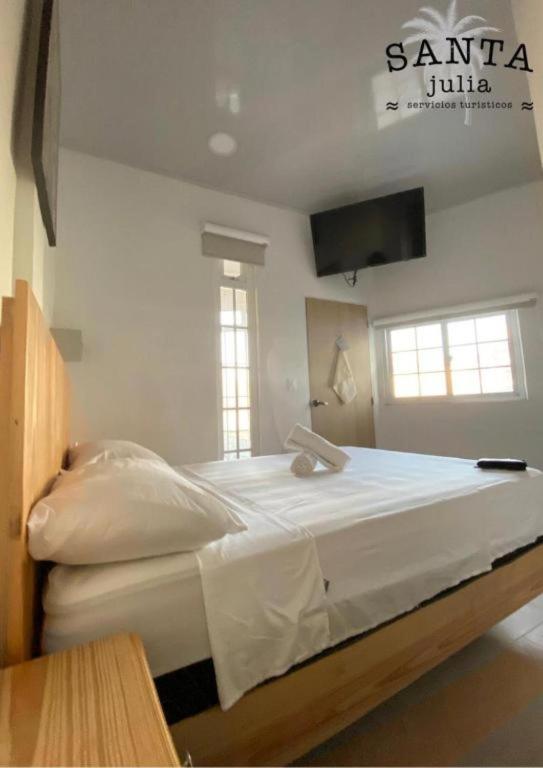 Cama ou camas em um quarto em Santa Julia Alojamiento
