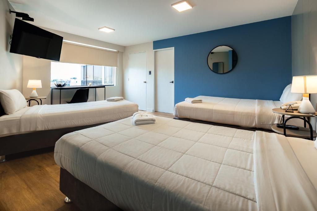 Postel nebo postele na pokoji v ubytování Miraflores Suites Centro