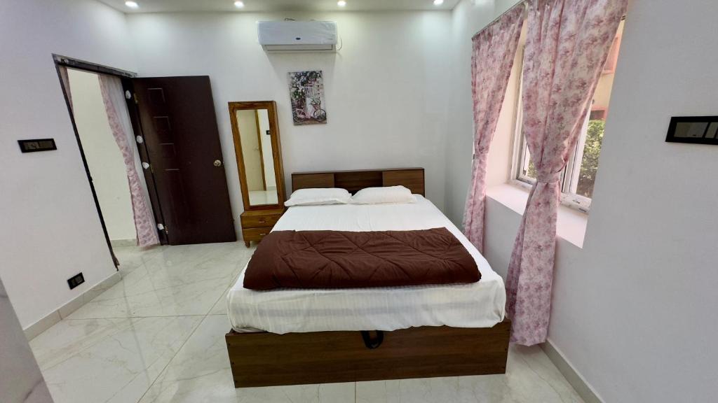a bedroom with a large bed in a room at Bhoomi mansion Homestay Apartment 12 in Bhubaneshwar