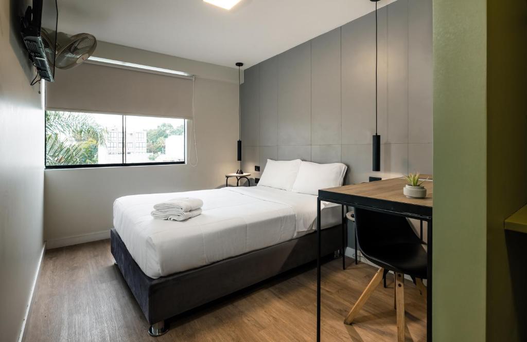 Postel nebo postele na pokoji v ubytování Miraflores Suites Centro