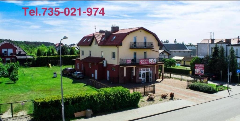 a large house on the side of a street at ADANIA 1 in Grzybowo