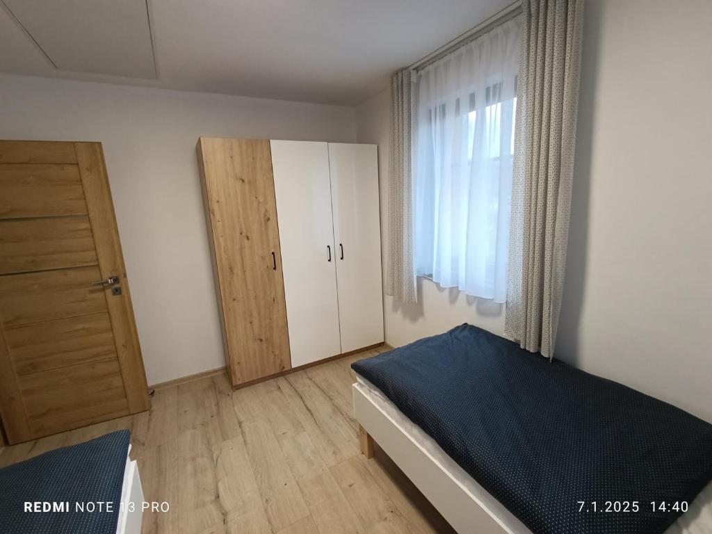 Postel nebo postele na pokoji v ubytování Apartmány Zdíkov