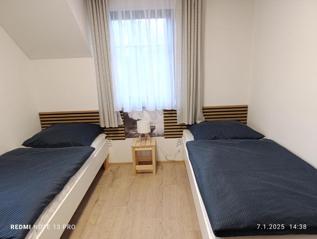 Postel nebo postele na pokoji v ubytování Apartmány Zdíkov