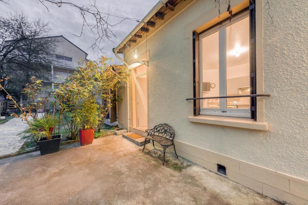 a bench sitting outside of a building with a window at Paisible, Paris, Tram 9mim, RER C 15min - Genius in Vitry-sur-Seine