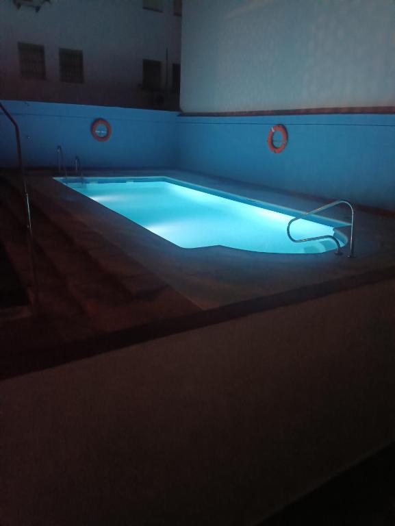 a swimming pool with a blue light in a room at La Casa del Mar in Barbate