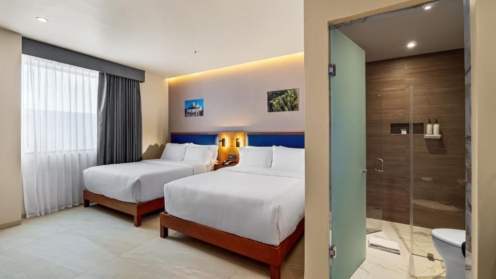 Postel nebo postele na pokoji v ubytování Hampton By Hilton Queretaro Juriquilla