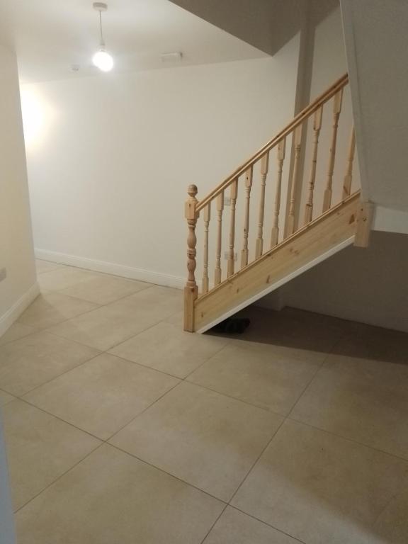 a staircase in a room with a tile floor at St Anthony s in Midleton
