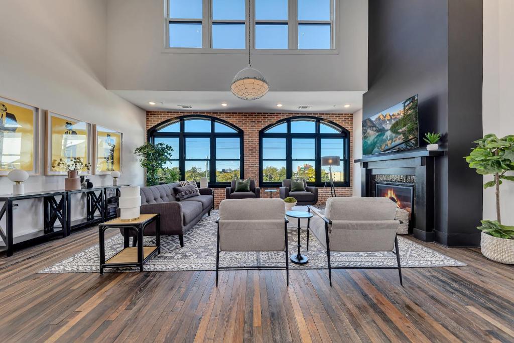 a living room with a couch and a fireplace at Top Floor Penthouse Lofts in Atlanta