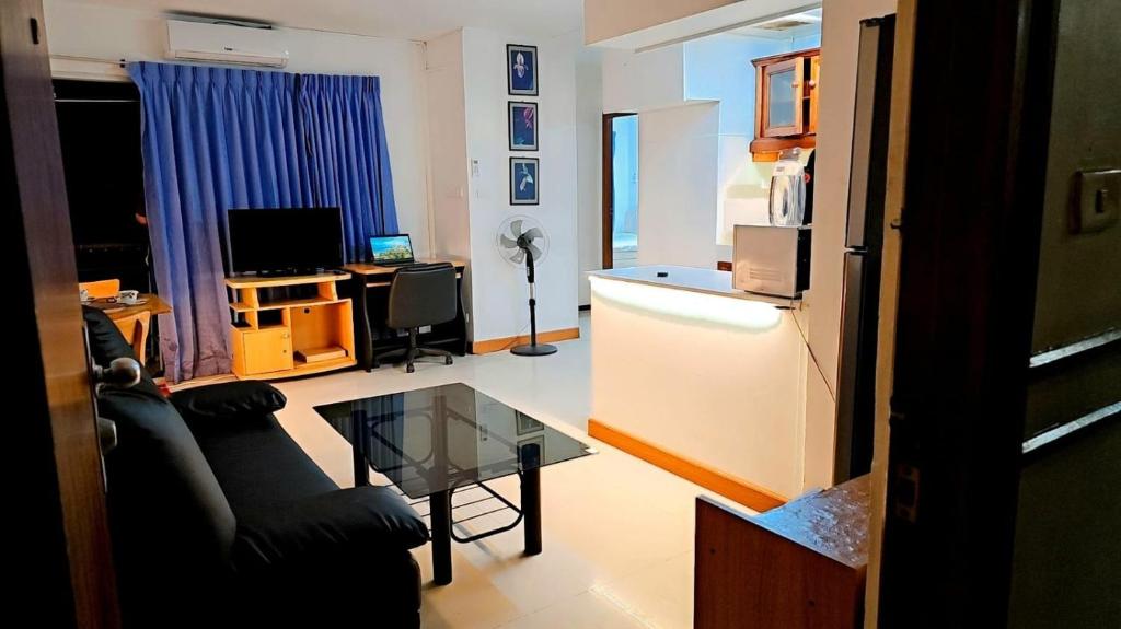 a living room with a couch and a table at River View Bangkok in Bangkok