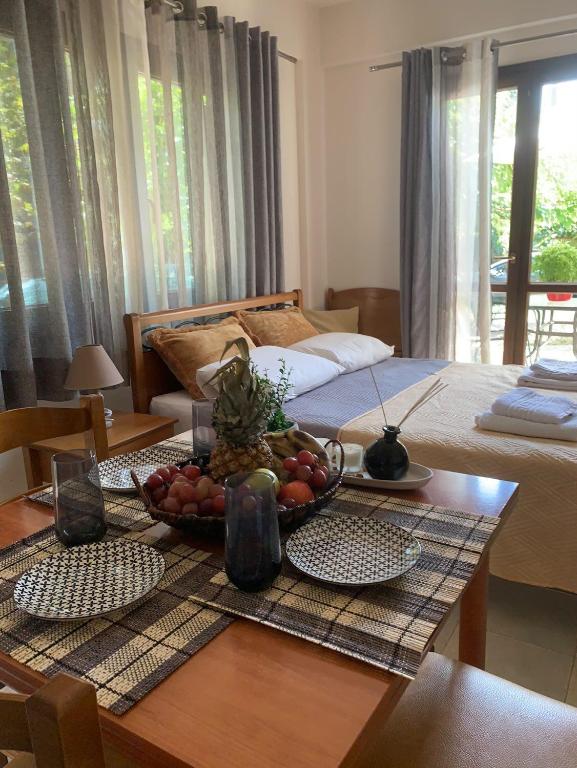 a room with a table with a bowl of fruit on it at Olympia's Seaside Lefokastro in Lefokastro