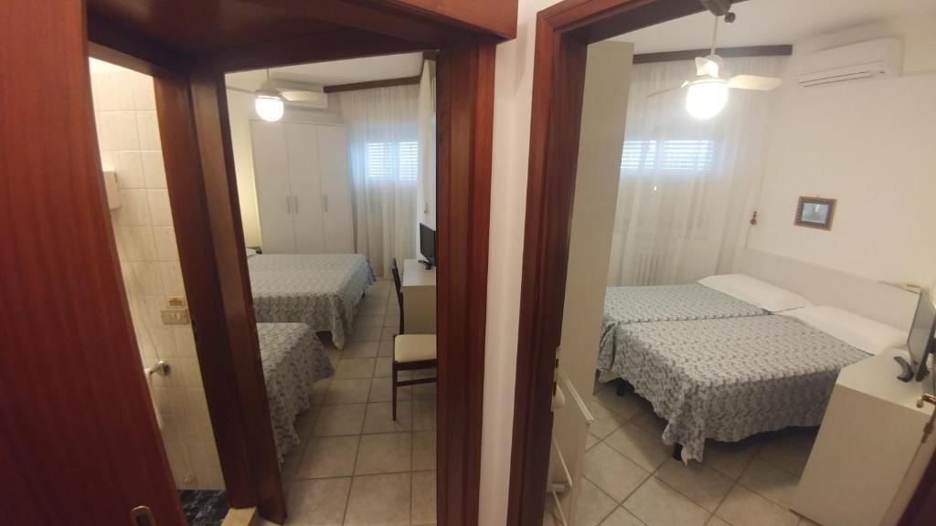 Postel nebo postele na pokoji v ubytování Amigos