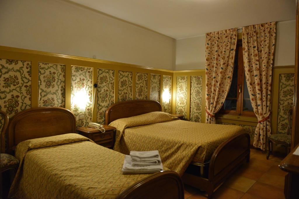 Posteľ alebo postele v izbe v ubytovaní Hotel Gufo